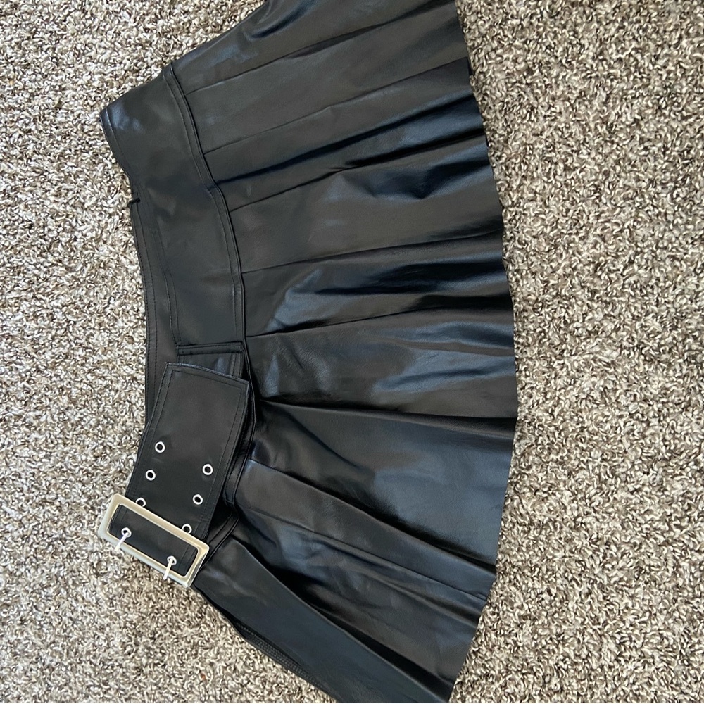 Black Leather mini skirt with side buckle.